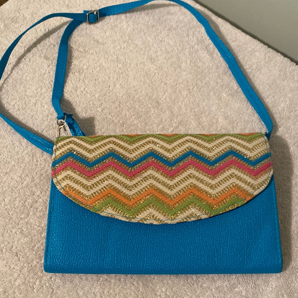 Small Purse very well kept used only once. Has a shoulder strap very cute.